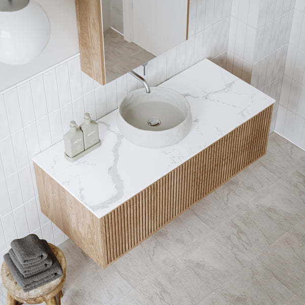 Ingrain Grooved wall hung vanity with white stone-look top, round basin and ash grooved drawer front, in bathroom setting