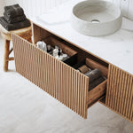 Ingrain Grooved wall hung vanity with fluted woodgrain drawers and white stone-look top in bathroom setting