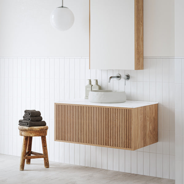 Ingrain Grooved wall hung vanity in ash woodgrain, with fluted drawer front and white basin in a modern bathroom