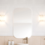 Timberline Jazz Arch Mirror in white satin finish, shown above a bathroom vanity with wall lights and tapware