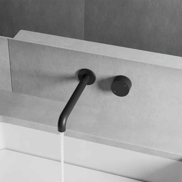 Nero Kara progressive wall basin/bath set in matte black, with curved wall-mounted spout and round handle above a basin edge