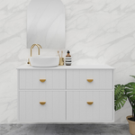 Marquis Anna wall hung vanity in matte white with four drawers, gold handles and round basin under arched mirror above marble-look wall