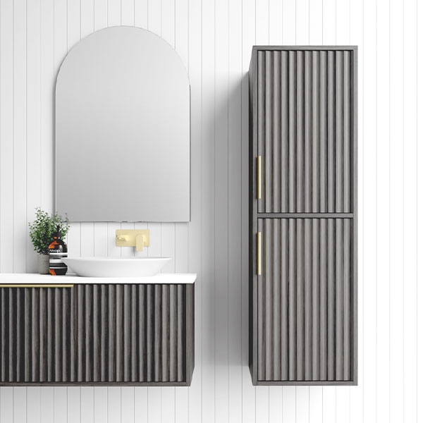 Marquis Cove wall-hung tallboy in fluted grey timber grain with brushed brass handles, shown beside matching vanity unit