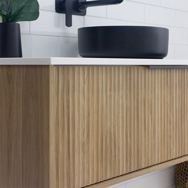 Marquis Cove wall hung vanity in Prime Oak fluted woodgrain finish with white top, close-up of cabinet front and basin edge