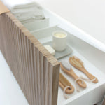 Marquis Cove wall hung vanity drawer detail in fluted timber grain finish, with white internal drawer organiser