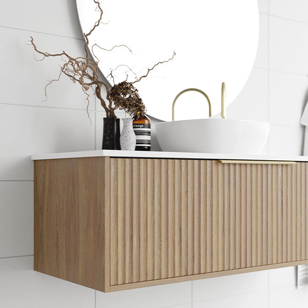 Marquis Cove wall hung vanity in prime oak with fluted timber grain, white top and brushed brass basin in bathroom setting