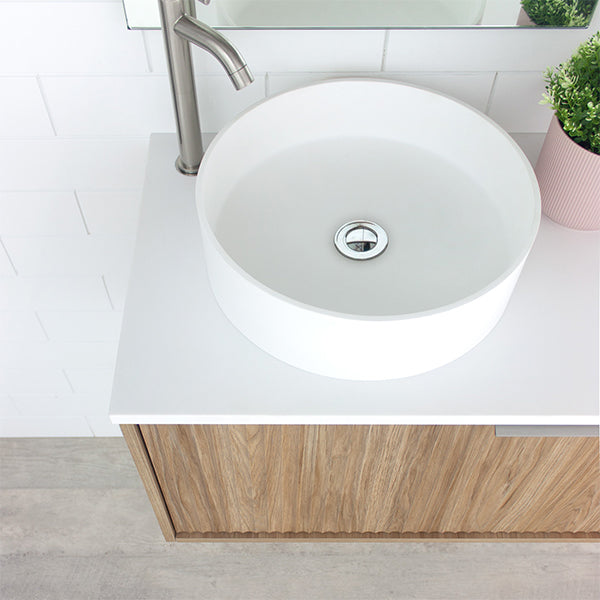 Marquis Cove wall hung vanity in prime oak with white benchtop and round above-counter basin, angled view