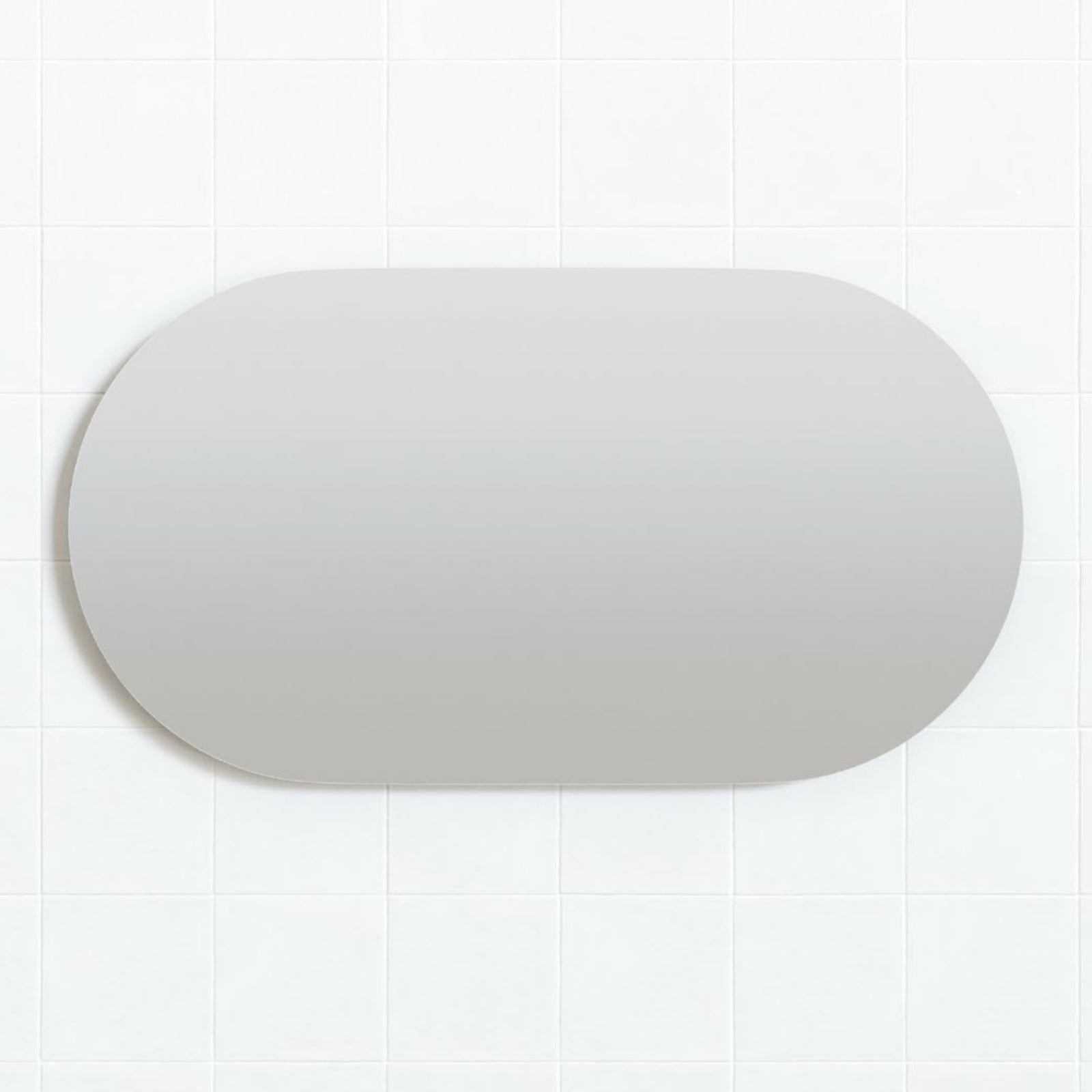 Marquis Culare frameless oval mirror in landscape orientation, shown against a white tiled wall