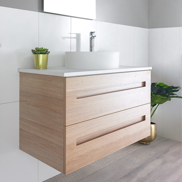 Marquis Gold wall hung vanity in natural oak with white basin and two drawers, shown in a bathroom setting