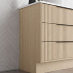 Marquis Lake floor standing vanity in coastal oak finish with fluted drawers and white benchtop, angled side view