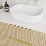 Marquis Lake wall hung vanity with white top, timber-look shiplap drawers and brushed brass handles, shown with above-counter basin