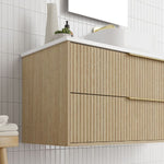 Marquis Lake wall hung vanity in coastal oak woodgrain with fluted drawers, white benchtop and brushed brass handles