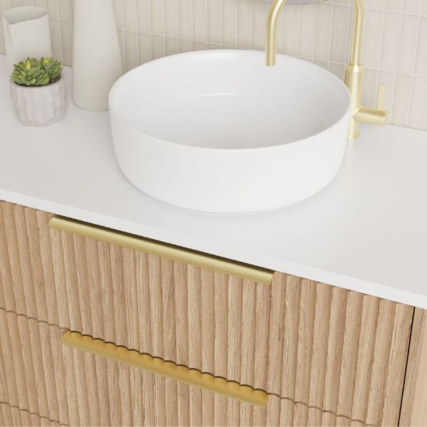 Marquis Lake floor standing vanity in coastal oak with white top, round basin and gold handles, close-up view