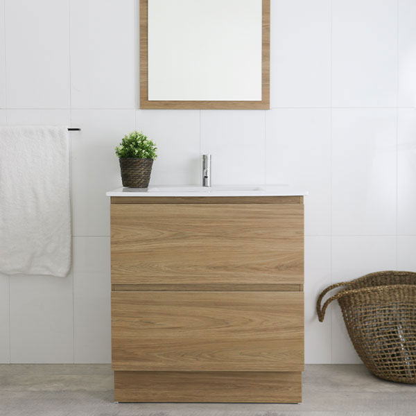 Marquis Marq floor standing vanity in woodgrain finish with white top and basin, shown in a bathroom setting