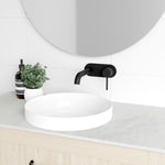 Marquis Pier wall hung vanity with light woodgrain finish, white top and round above-counter basin in bathroom setting