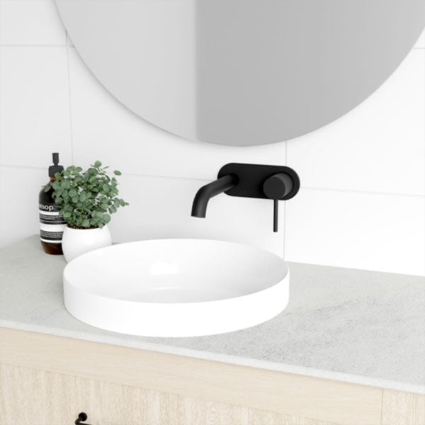 Marquis Pier wall hung vanity with light woodgrain finish, white top and round above-counter basin in bathroom setting