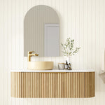 Marquis Shore wall hung vanity with fluted woodgrain drawer, white solid surface top and round basin in a bathroom setting