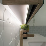 Close-up of ADP Moonlight shaving cabinet LED, showing concealed under-cabinet lighting and mirrored edge in natural oak finish