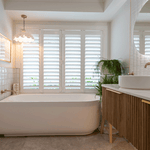 Timberline Santos Apollo wall hung vanity with fluted woodgrain front, white top and above counter basin in bathroom setting