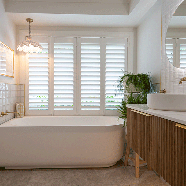 Timberline Santos Apollo wall hung vanity with fluted woodgrain front, white top and above counter basin in bathroom setting