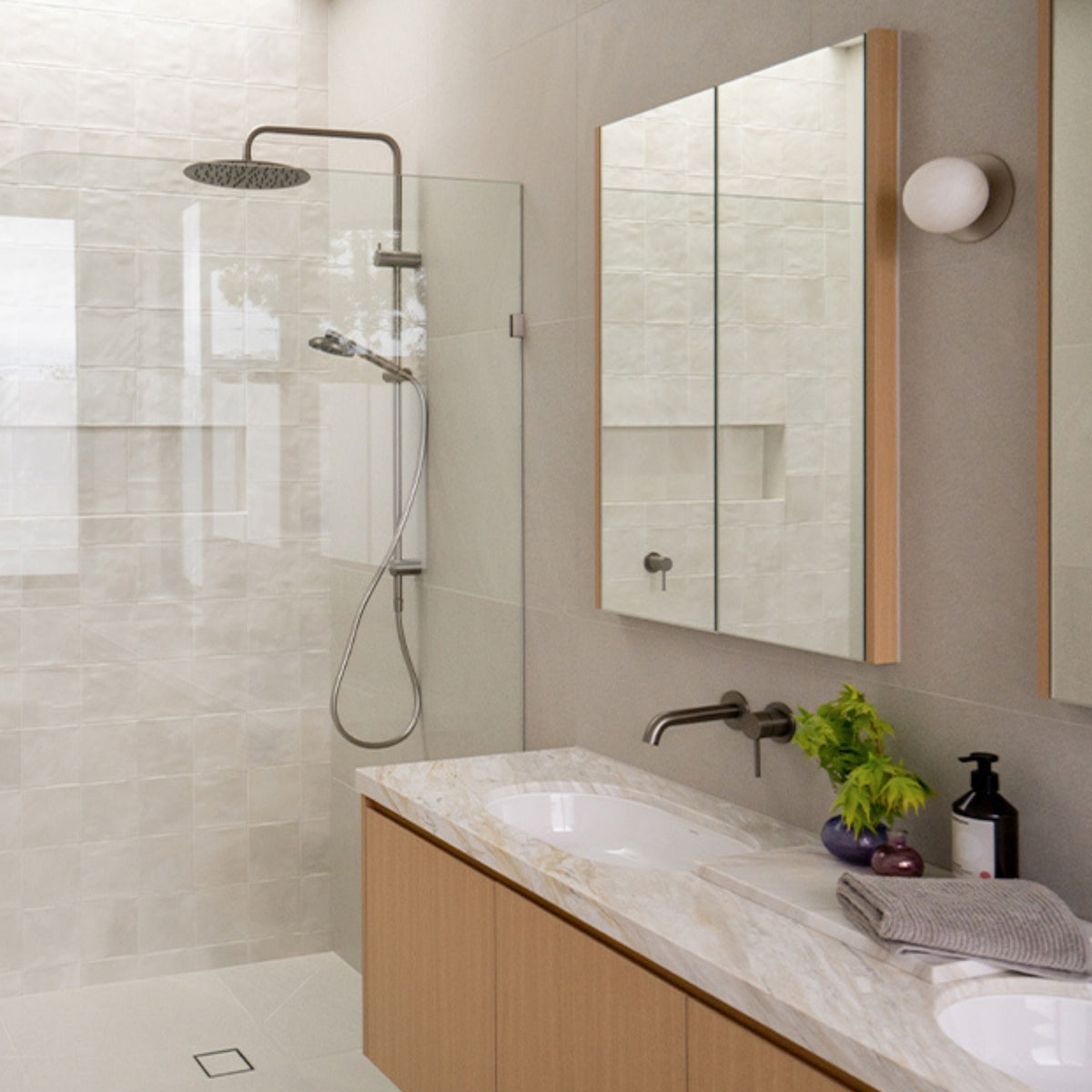 Caroma Urbane II brushed nickel twin rail shower with round overhead rose in a modern bathroom setting