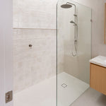 Caroma Urbane II brushed nickel twin rail shower in a modern bathroom, with round overhead rain shower and handheld spray.