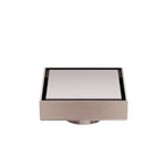 Nero square tile insert floor waste in brushed bronze with 50mm outlet, shown front on against white background
