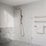 Nero Bianca brushed bronze single heated towel rail in a modern bathroom, shown with a white towel on the wall