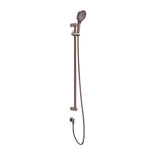 Nero Mecca Care shower rail set in brushed bronze, with adjustable hand shower and hose on a wall-mounted rail.