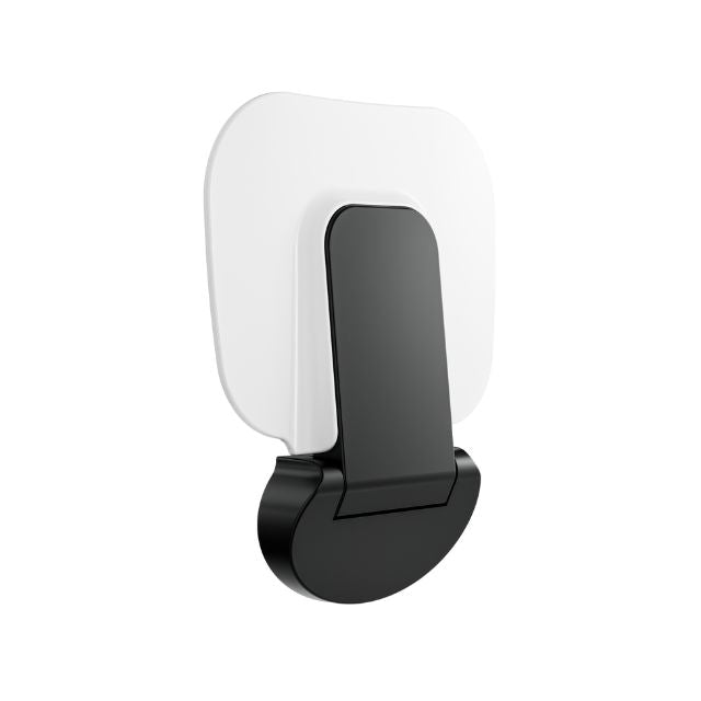 Nero Mecca Care wall-mounted shower seat in matte black, folded up against a white backplate