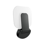 Nero Mecca Care wall-mounted shower seat in matte black, folded up against a white backplate