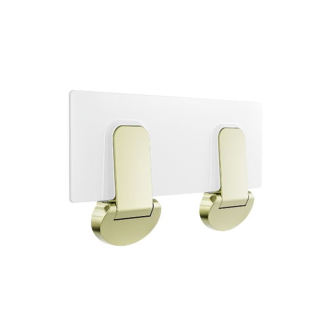 Nero Mecca Care fold-down shower seat in brushed gold with white seat panel, wall-mounted bathroom accessory