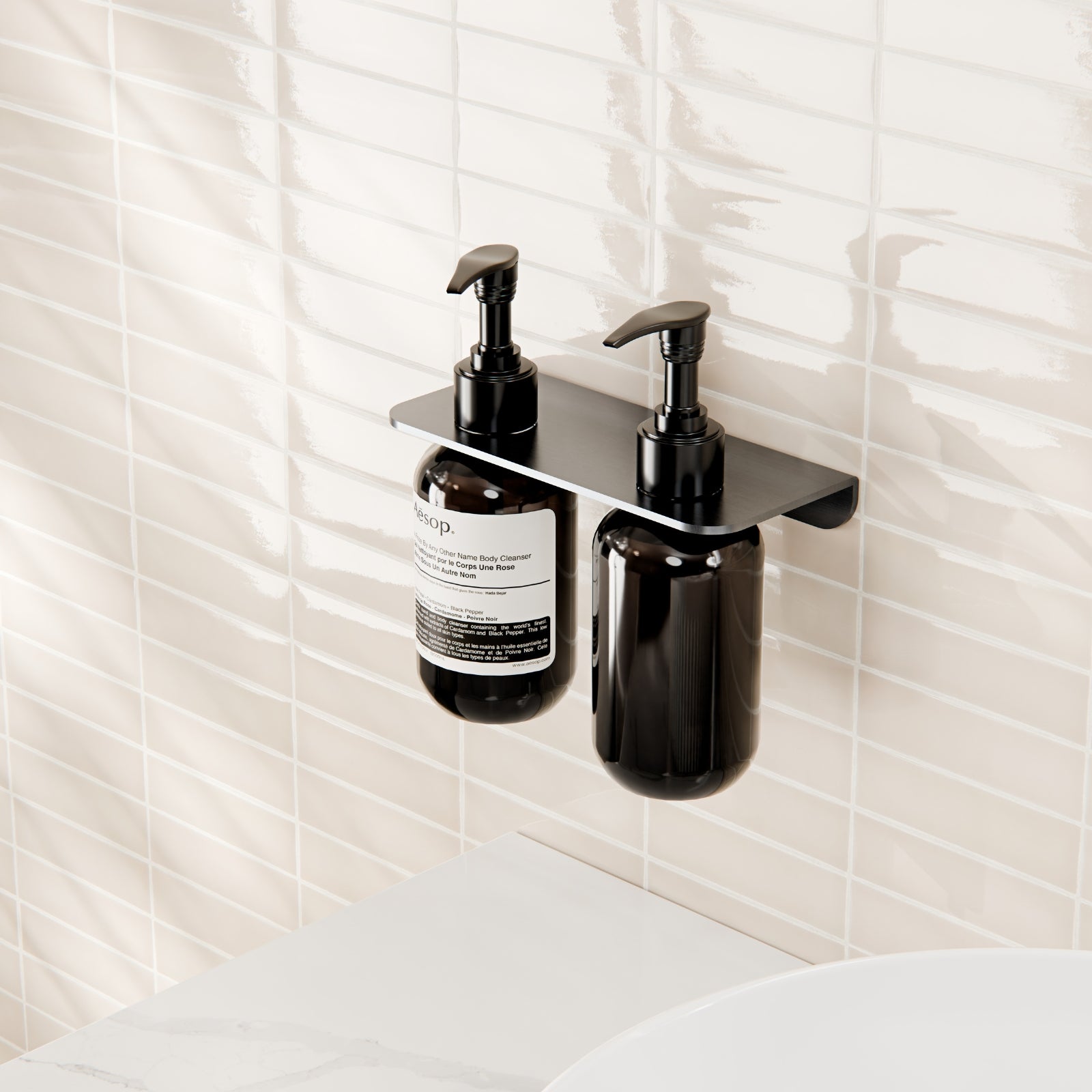 Nero Mecca double soap bottle holder in gun metal, wall-mounted with two pump bottles in a modern bathroom setting