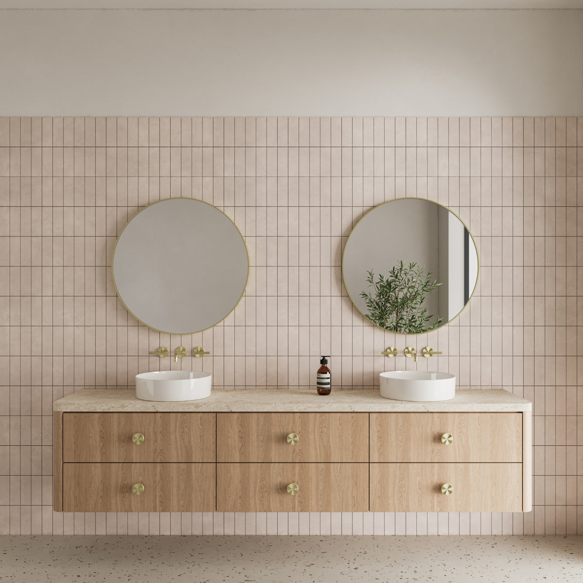 Wall-mounted Nero Mecca 3 piece basin/bath set in brushed gold above a twin vanity with round mirrors and basins