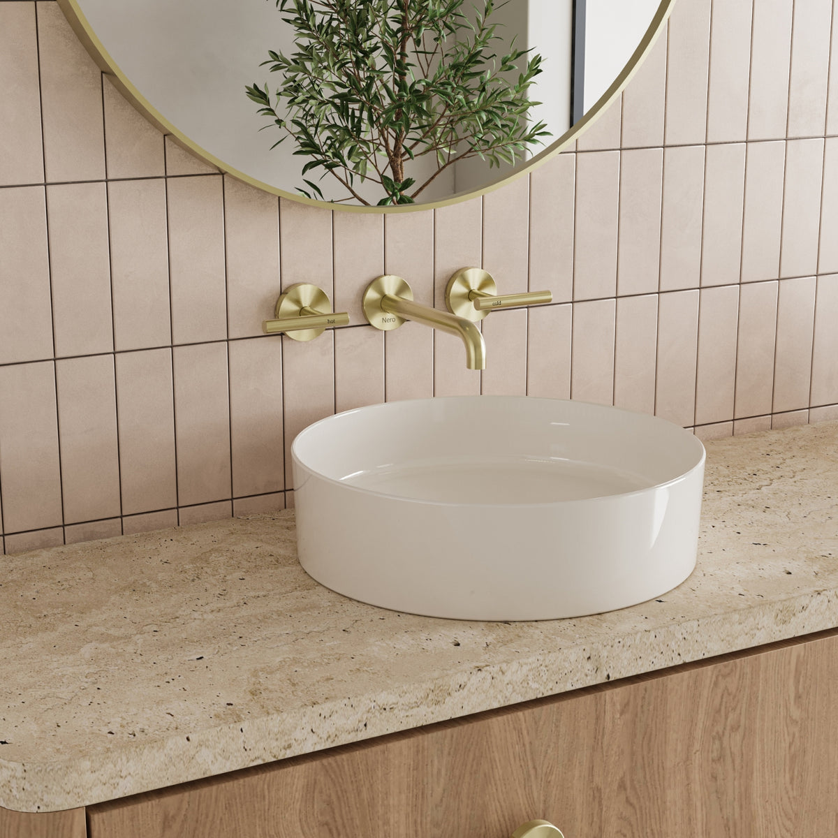 Nero Mecca wall basin set in brushed gold, with lever handles and 185mm spout above a round basin in a bathroom setting