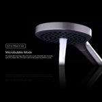 Close-up of Nero Mecca twin shower head in brushed bronze with microbubble mode, showing overhead drencher and handset spray
