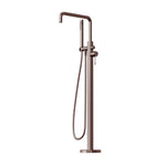 Nero Opal freestanding bath mixer with hand shower in brushed bronze, floor-mounted tap on white background