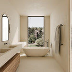 Matte graphite wall basin mixer set with separate back plate installed above a freestanding bath in a modern bathroom