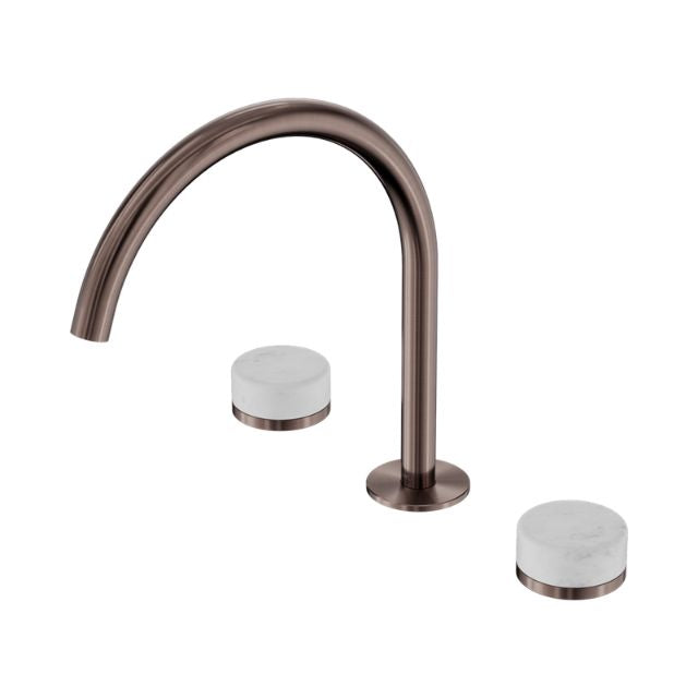 Nero Serenity brushed bronze arc spout tap set with white Carrara marble handles, three-piece sink set on white background