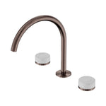 Nero Serenity brushed bronze arc spout tap set with white Carrara marble handles, three-piece sink set on white background