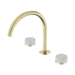 Nero Serenity wall-mounted 3 piece tap set in brushed gold with curved arc spout and Carrara marble handles on white background