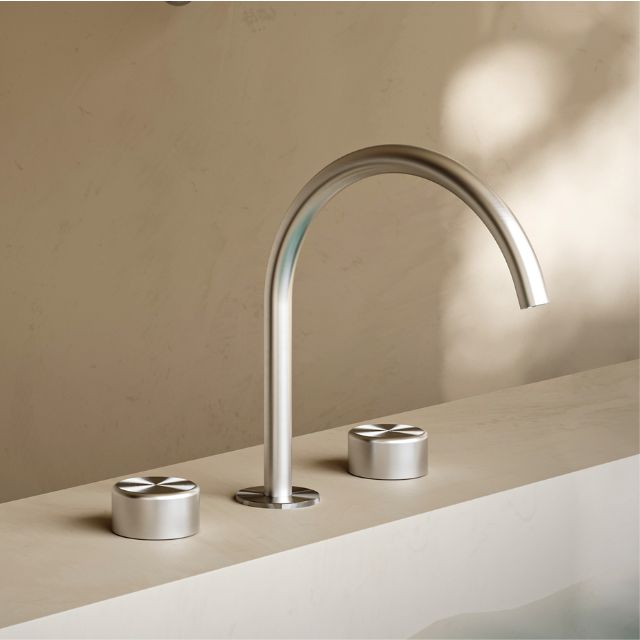 Nero Serenity brushed nickel 3-piece sink set with arc spout and metal handles on a benchtop view