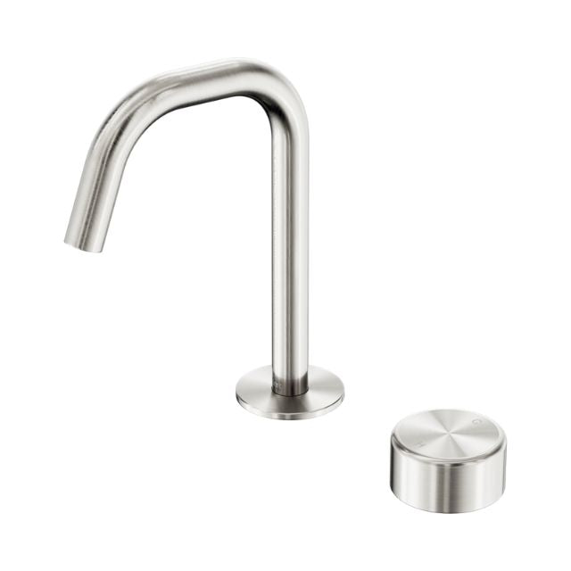 Nero Serenity basin mixer tap in brushed nickel with edge spout and metal handle, shown with round base and control cap