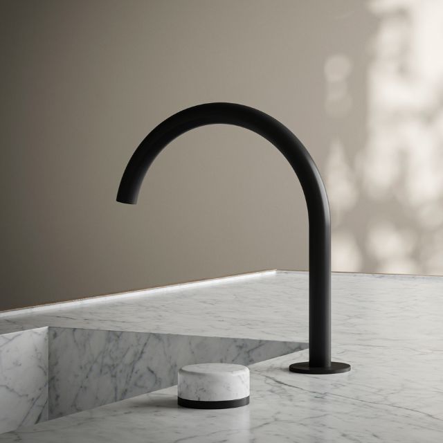 Nero Serenity matte black progressive mixer tap with arc spout and Carrara marble handle on a marble benchtop