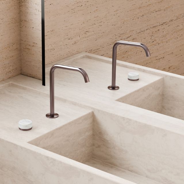 Nero Serenity brushed bronze gooseneck mixer taps on a stone double basin, side view, with squared spouts and marble handles