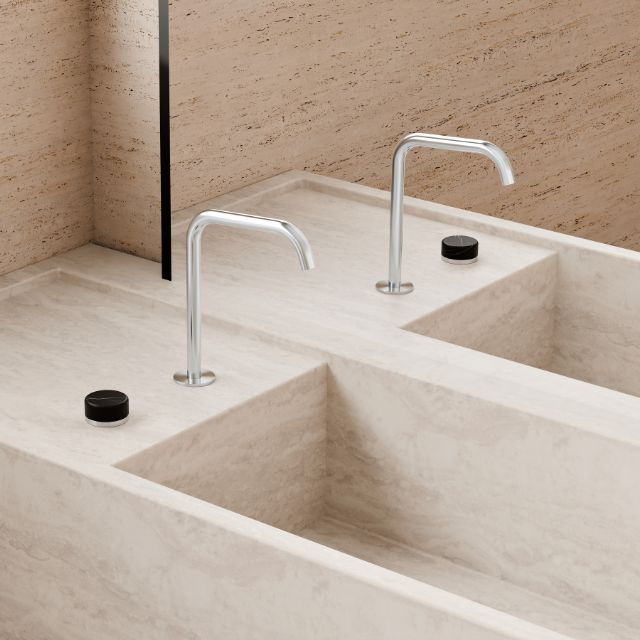 Nero Serenity chrome progressive mixer with edge spout, shown in a bathroom vanity setting with twin black handles/png?
