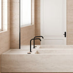 Nero Serenity progressive mixer tap in matte black with Rome travertine handle, shown on a stone benchtop with square edge spout.