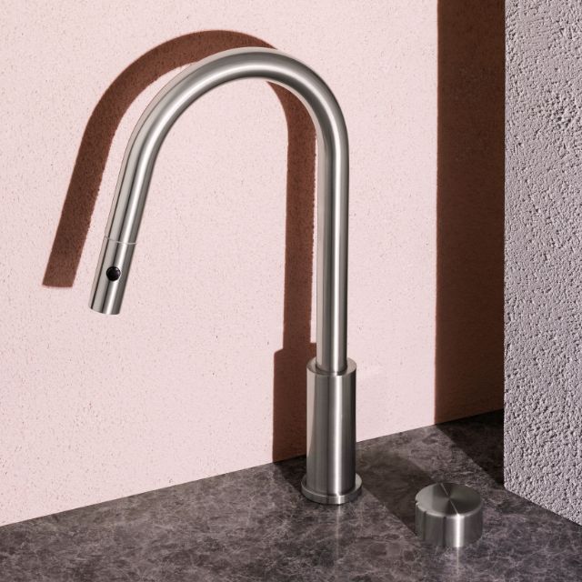 Nero Serenity pull-out kitchen mixer in brushed nickel, shown in side view with curved gooseneck spout and separate metal handle on benchtop