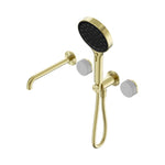 Nero Serenity progressive shower system in brushed gold with spout, Carrara marble handle and hand shower on white background