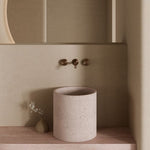 Nero Serenity wall basin set in brushed bronze with 160mm spout and metal handles above a round basin, bathroom setting